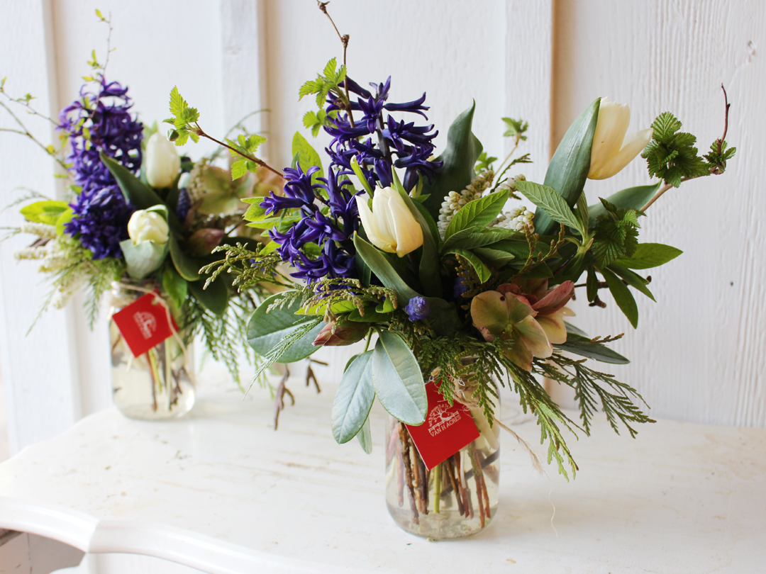 Seasonal spring vases with hellebore, hyacinth, and tulips